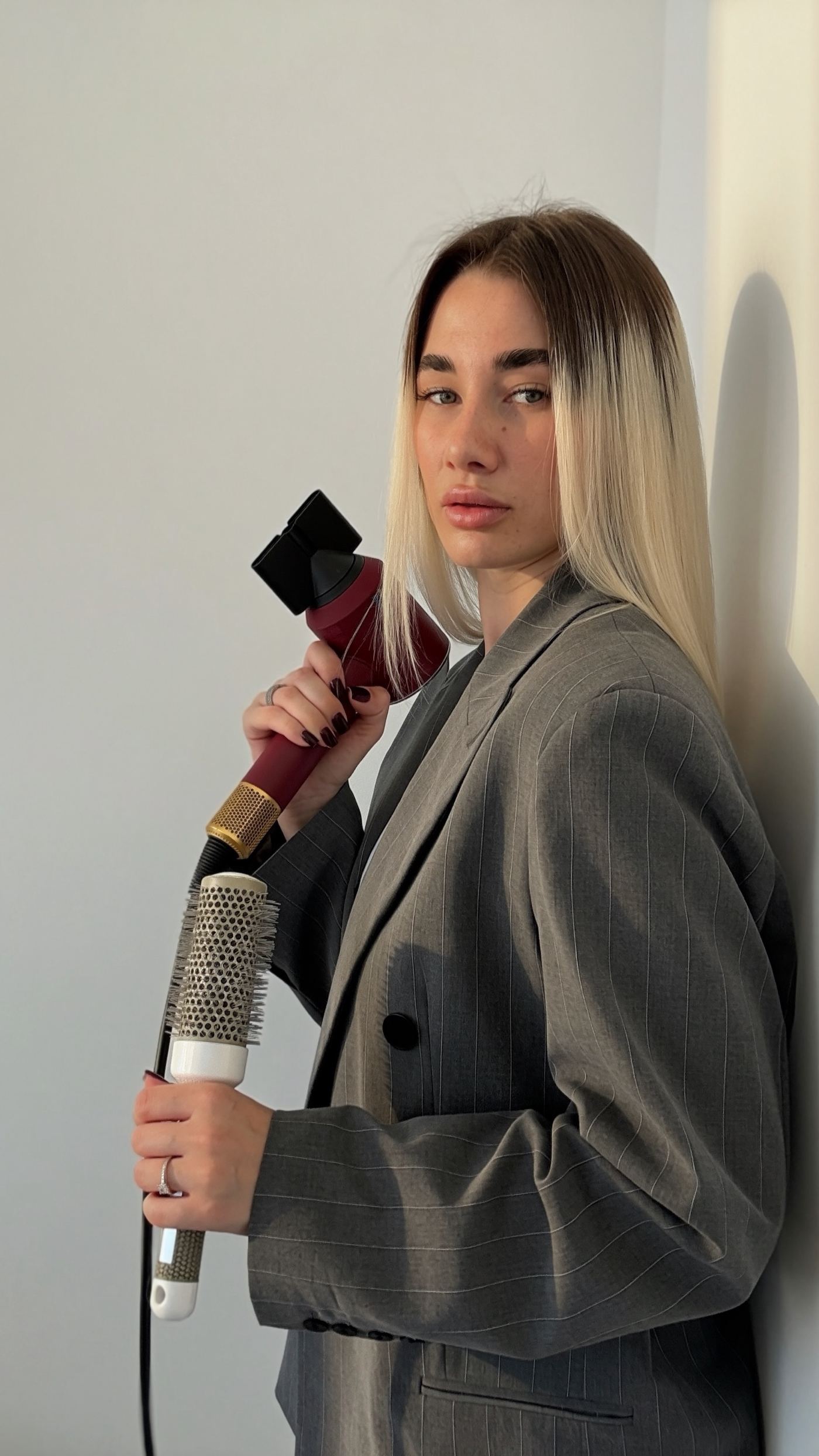 Anastasiia Tupalo, hair stylist, holding scissors